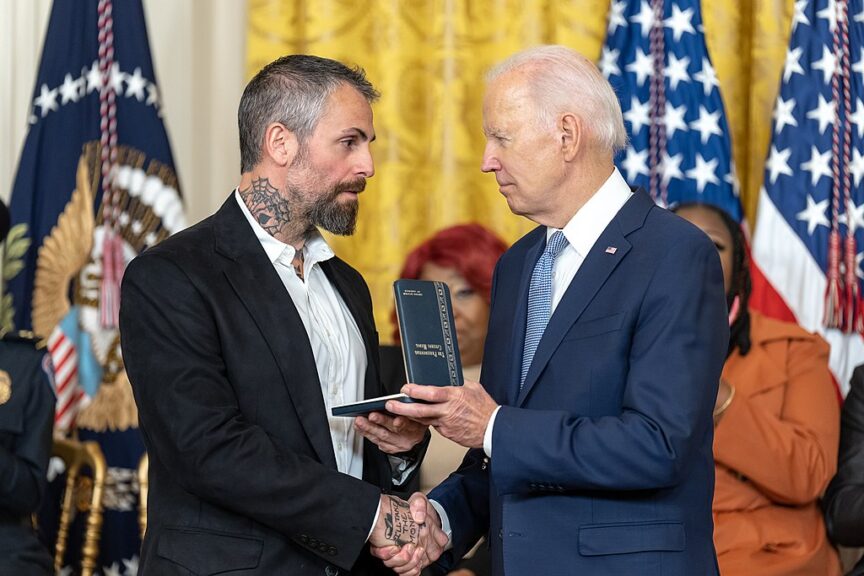 Officer michael fanone receives an award from president joe biden