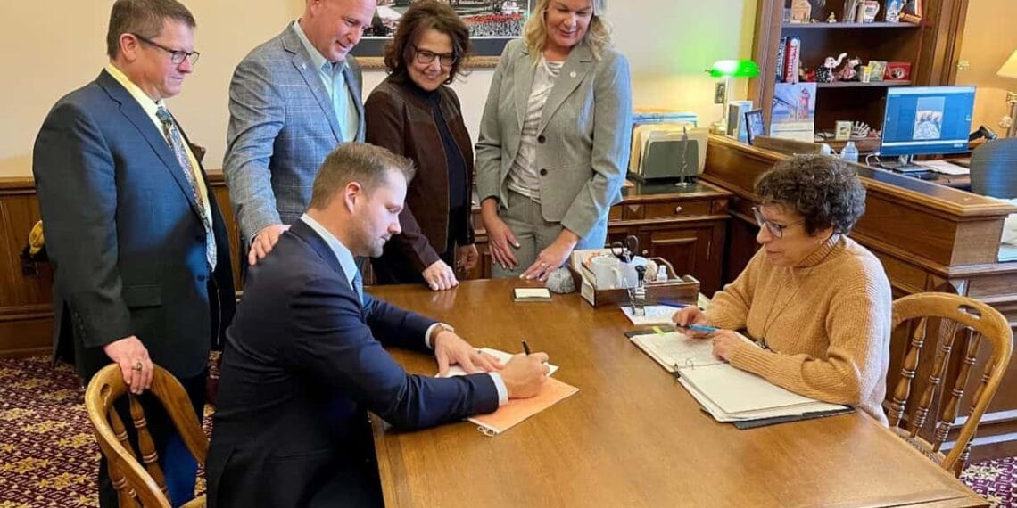 Co-sponsors of michigan legislation to require proof-of-citizenship for voting look on as state rep. Bryan posthumus submits the bill to the clerk. The co-sponsors are, from left, reps. Brian begole, jay deboyer, ann bollin, and rachelle smit. Smit, bollin, and deboyer are former election clerks.