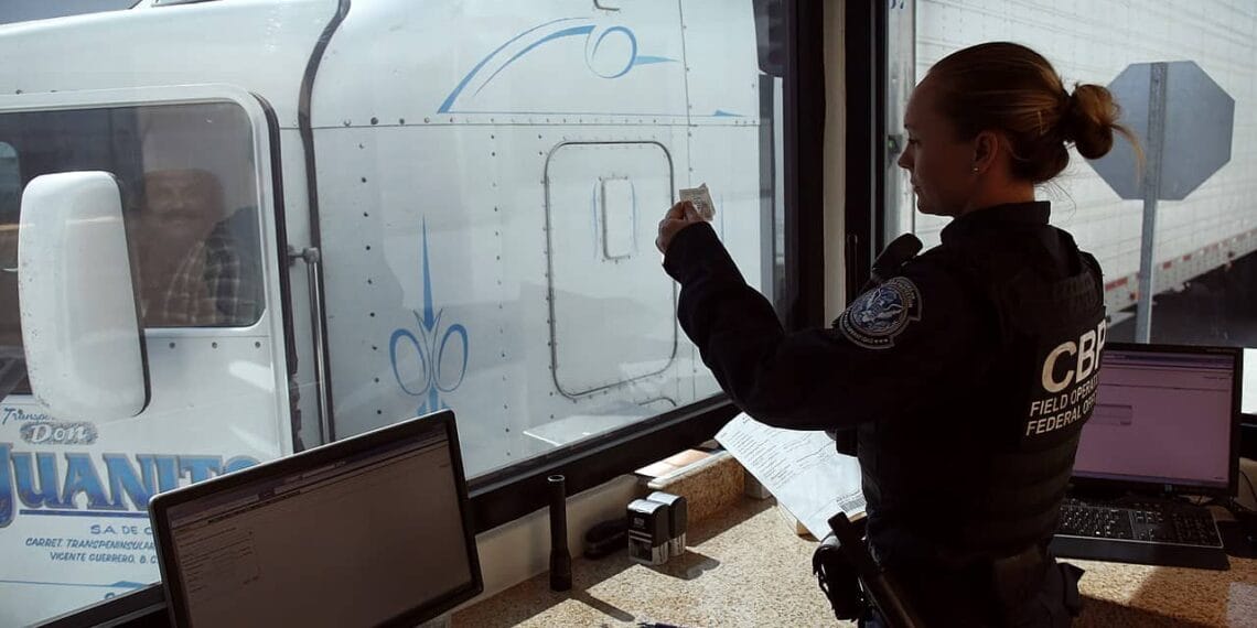 A u. S. Customs and border protection officer checks the identification of truck driver as he passes through the u. S. Checkpoint of the cargo pre-inspection at the otay mesa, calif. , port of entry, june 22, 2016. On any given day, several hundred trucks line up on the mexican side of the border to deliver imports ultimately awaiting the process of screening by customs officers.