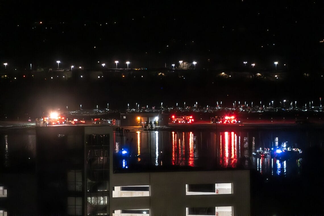 Coast guard and other first responders after a plane and helicopter collided in midair and fell into the potomac river.