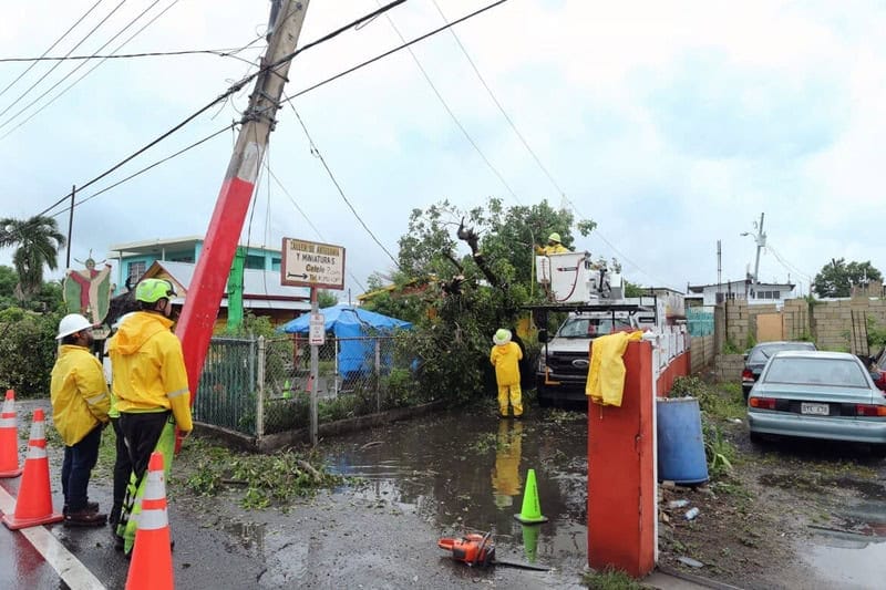 Downed power lines and tree branches a clean up crew is working