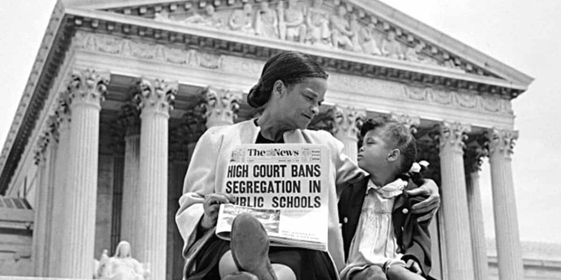 Authoritarian power grab. Mother and daughter sitting on steps in front of scotus, mother holds a newspaper with headline about segregation