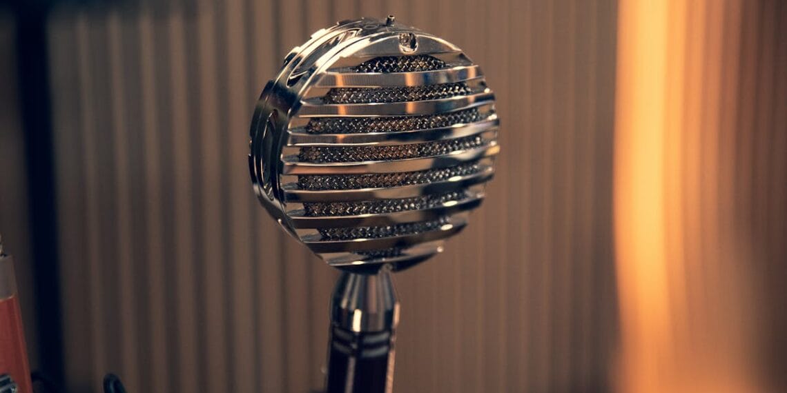 Close-up of a vintage microphone with a striped background in a studio environment.