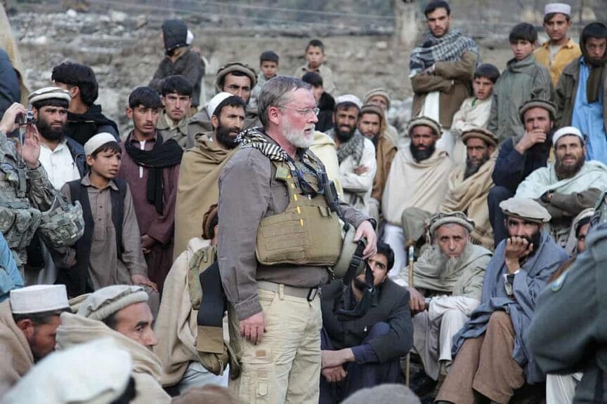 Federal aid worker speaking to aghan citizens
