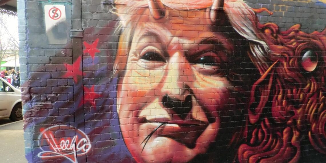 Donald trump is a fascist. Graffiti of trump as a snake with devil horns on a wall