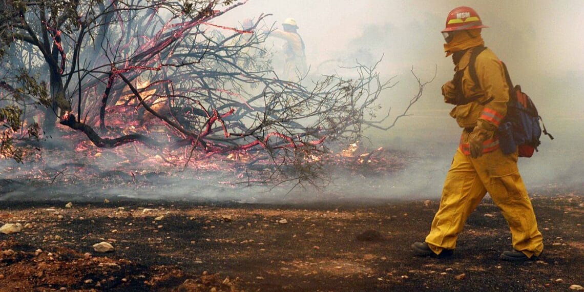 Fire fighters from the miramar fire dept. Fight a small brush fire on the east side of a hanger aboard marine corps air station (mcas) miramar, calif.