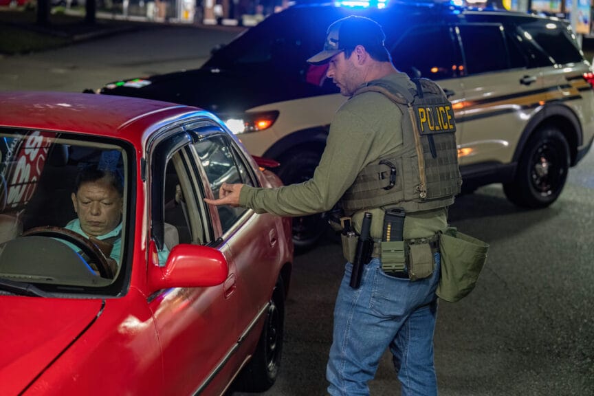 An immigration and customs enforcement agent pulls a driver over in nashville’s madison community on friday, march 9, 2025. A tennessee highway patrol vehicle is parked behind the man.