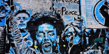 Social media vetting of student visa applicants began after student arrests for protesting. Urban art on a building of protesters.