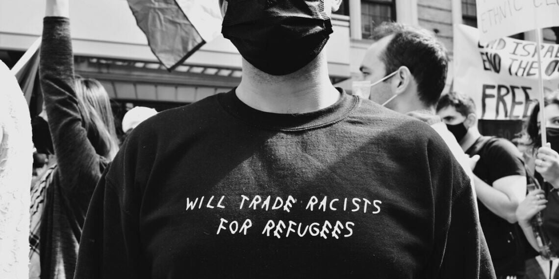 Protected status holders are supported by advocates like this protester.