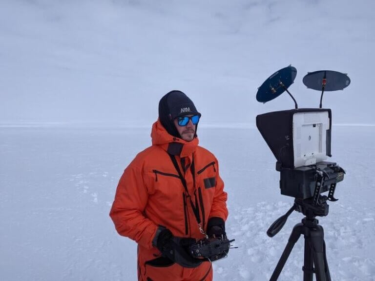 Scientist in antarctica studying penguin guano