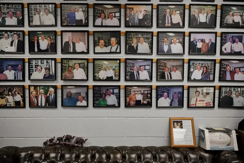 Photos hanging in his office of bean posing with people.