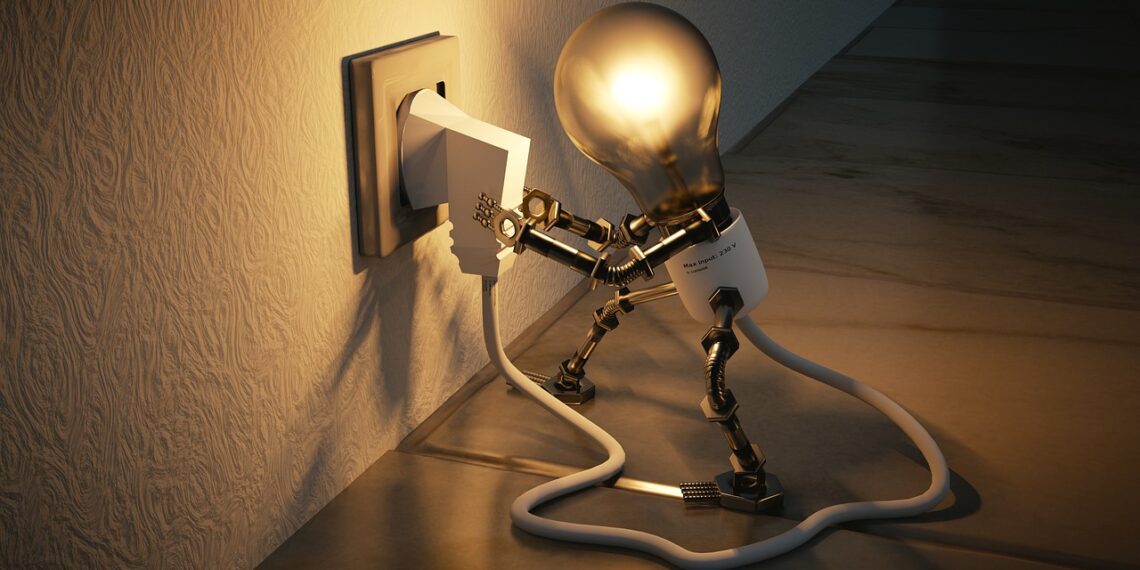 Lightbulb plugging itself into a wall socket.